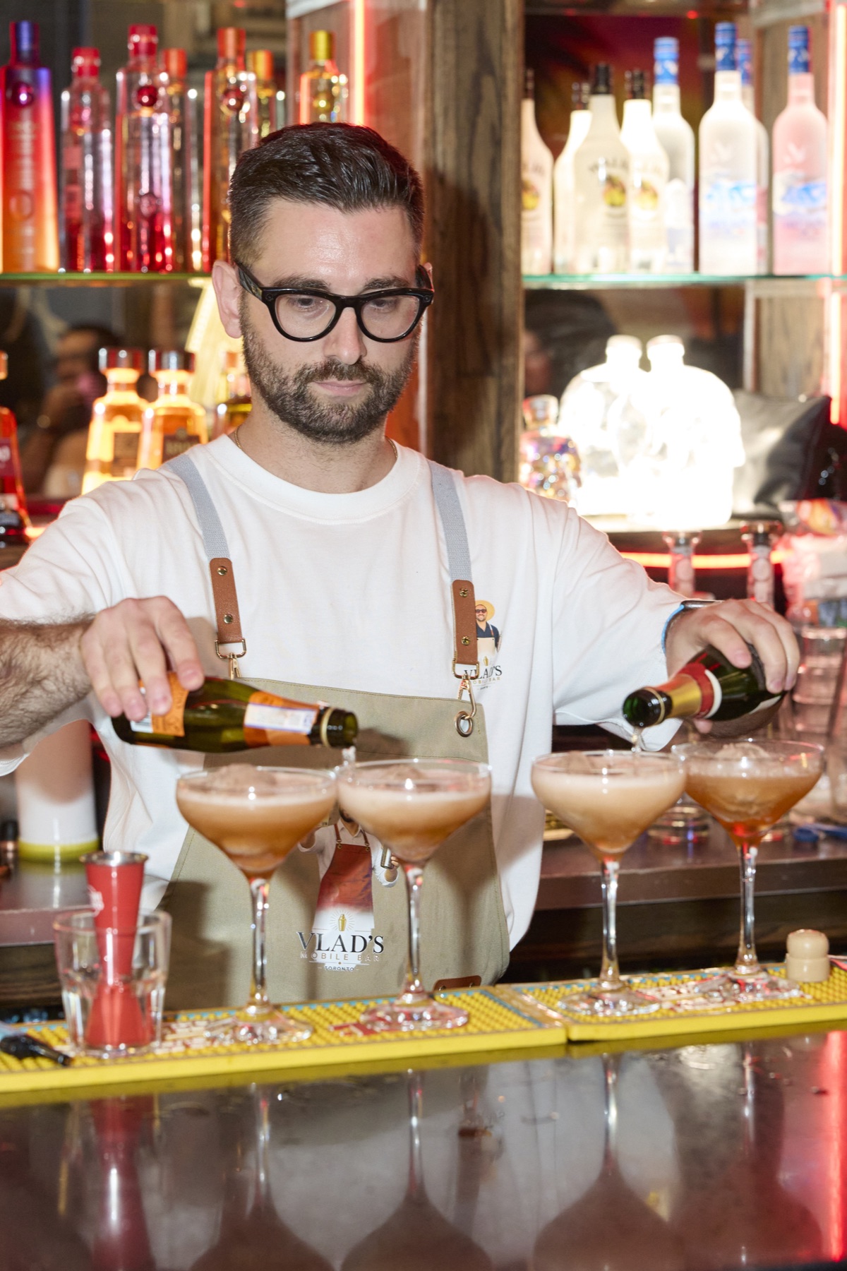 Vlad Mobile Bartender pouring sparkling wine into cocktails